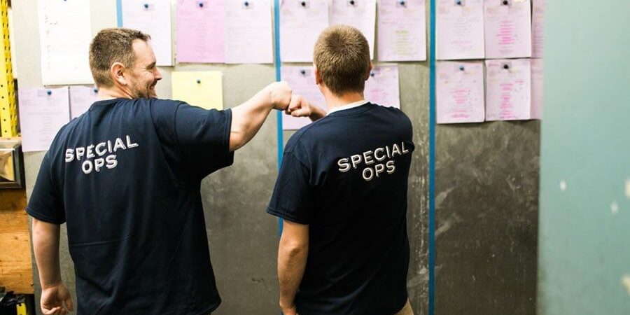 2 men bumping fists | Lisa Dupar Catering | Wedding & Event Catering in Seattle